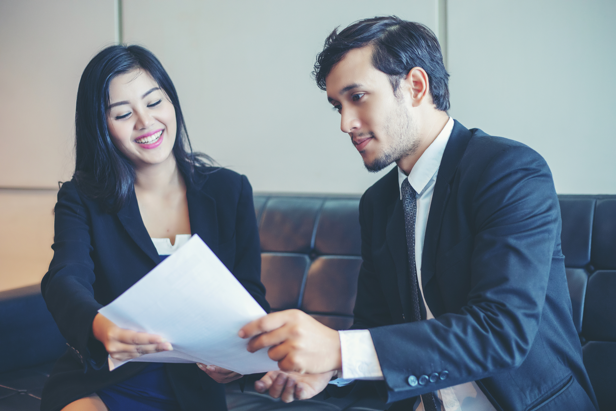 Common Mistakes To Avoid When Choosing A Business Entity - Businessmen and Businesswomen discussing documents and ideas in