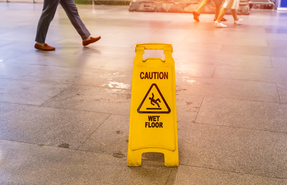 Understanding The Basics Of Premises Liability - "Caution wet floor" sign in mall